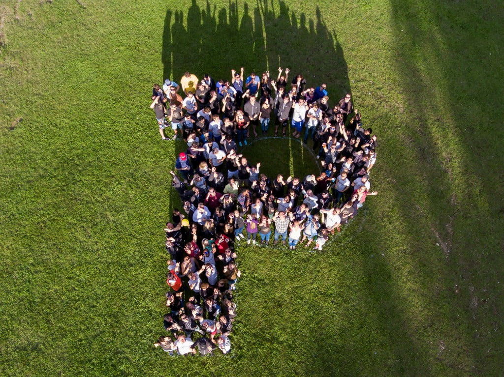 Aerial image of a group of people making a P