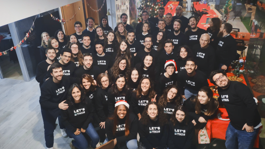+30 people wearing the same black sweatshirt at a Christmas party
