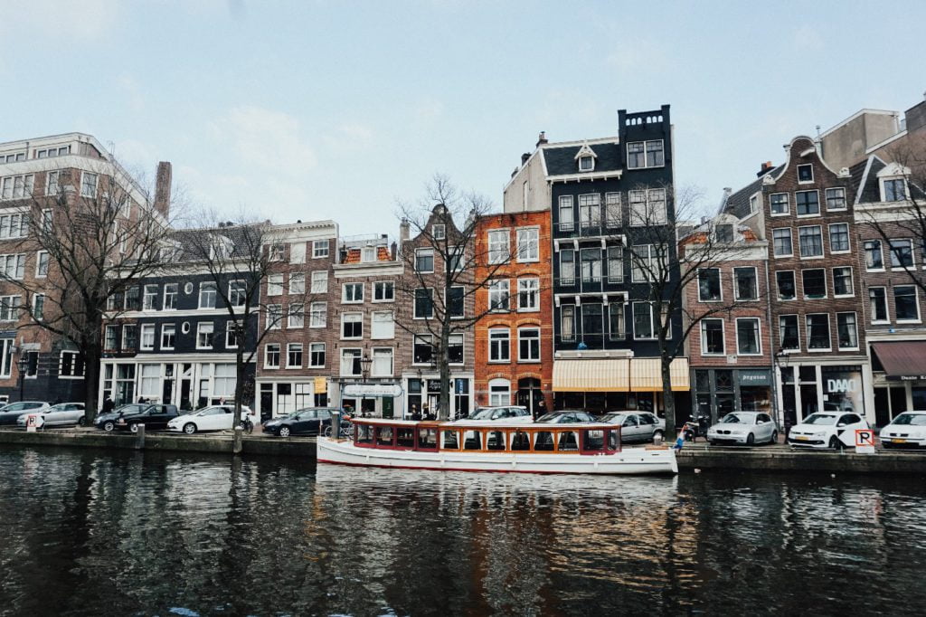 Typical houses from Amsterdam with a boat on the canal