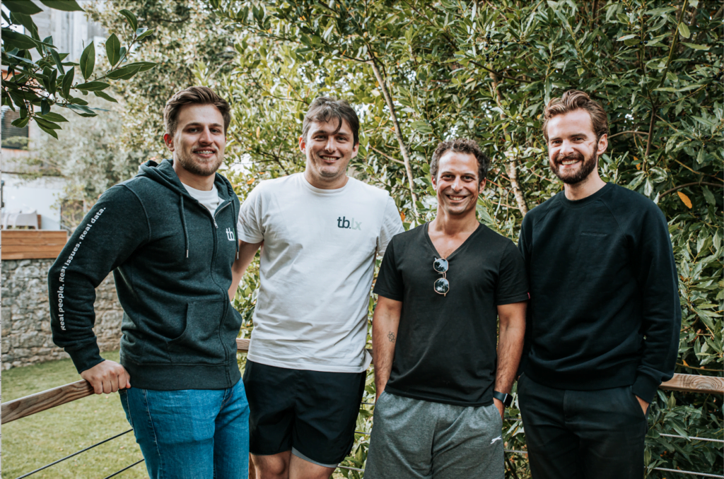 Four men facing the camera smiling. Part of tb.lx’s eMobility team