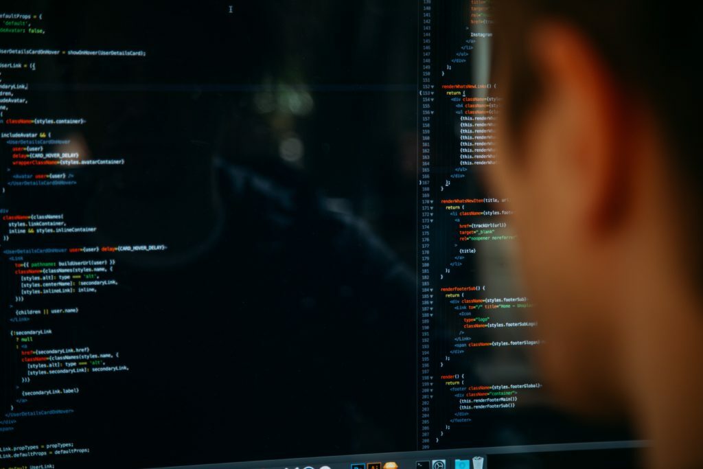developer looking at lines of code in his computer screen
