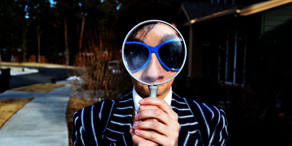 person using magnifying glass
