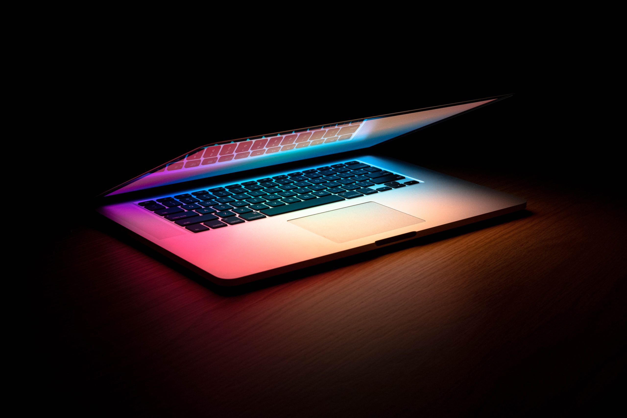 macbook semi-open in the dark