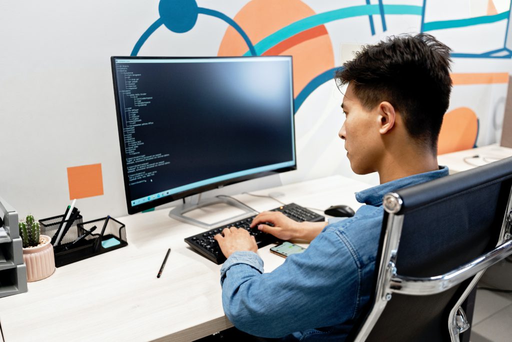 male developer coding on computer