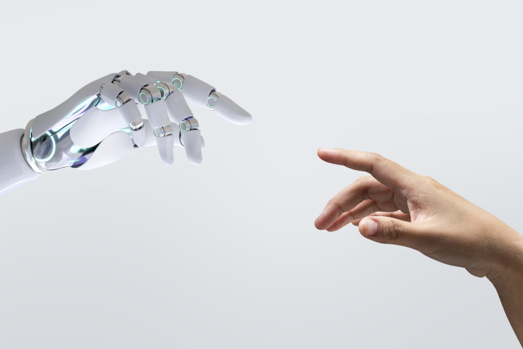 robot and human hands pointing at each other