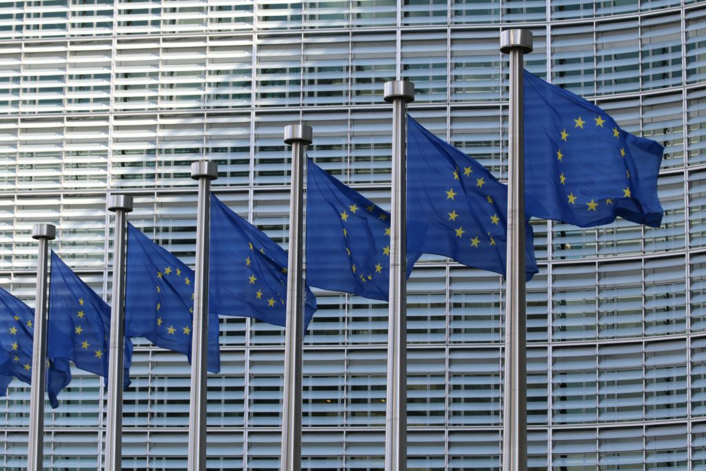 7 European Union flags in a pole to show how important the Pay Transparency gap is